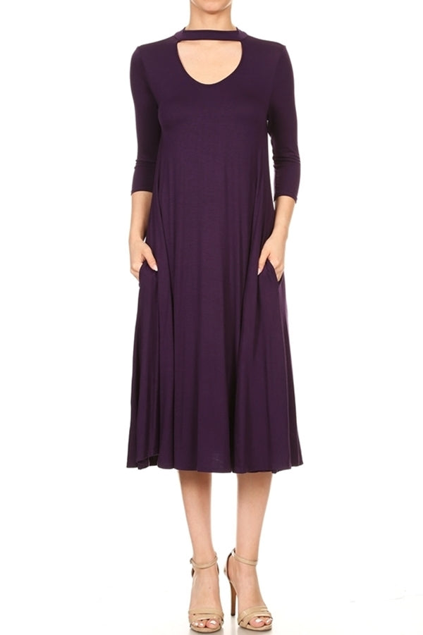 Woman wearing a dark purple A-line cocktail dress with keyhole neckline and choker collar