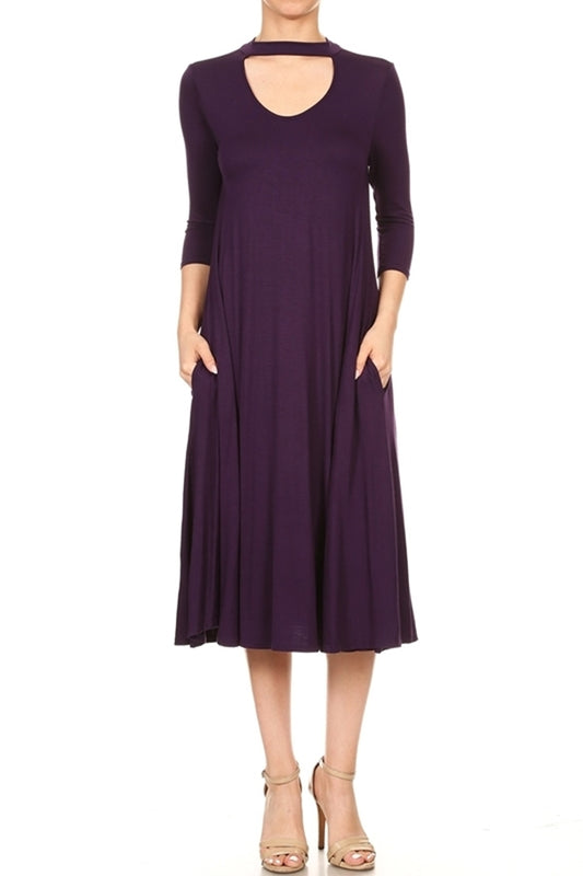 Woman wearing a dark purple A-line cocktail dress with keyhole neckline and choker collar