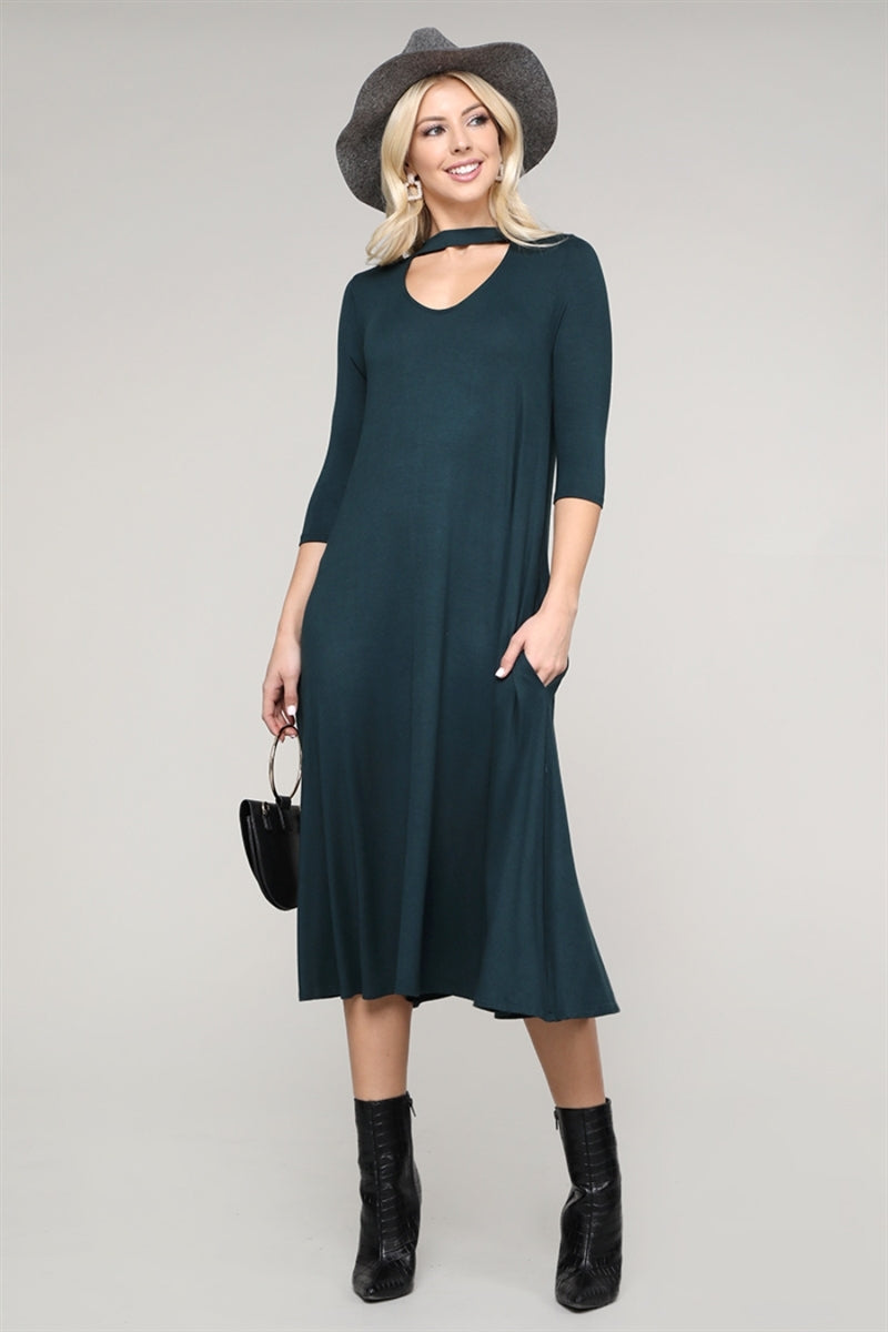 Elegant green dress featuring three-quarter sleeves and a keyhole cutout neckline