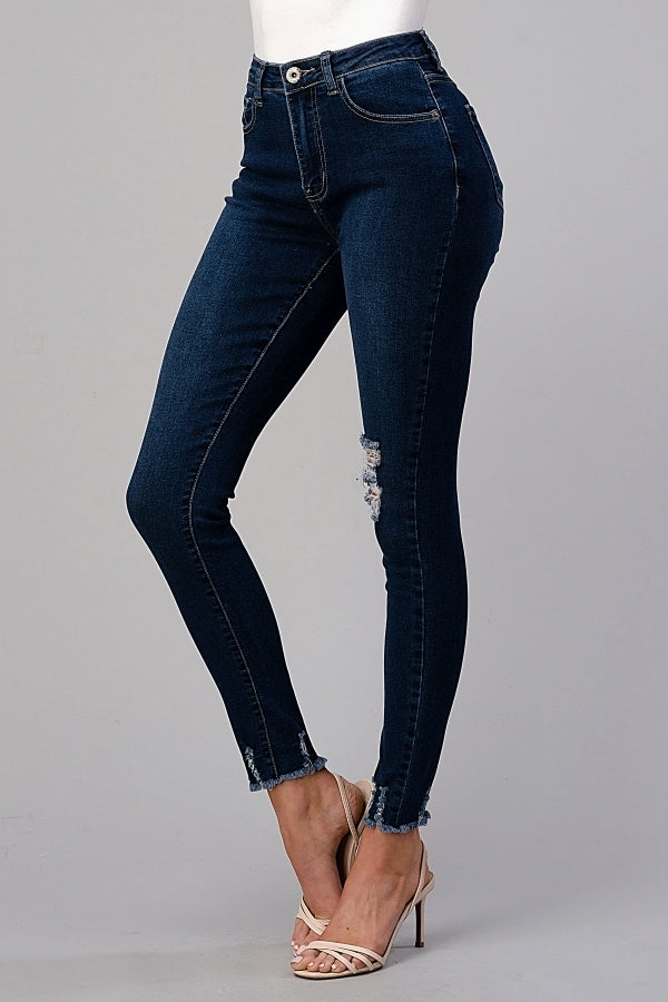 Model wearing American Blue distressed skinny denim jeans for juniors